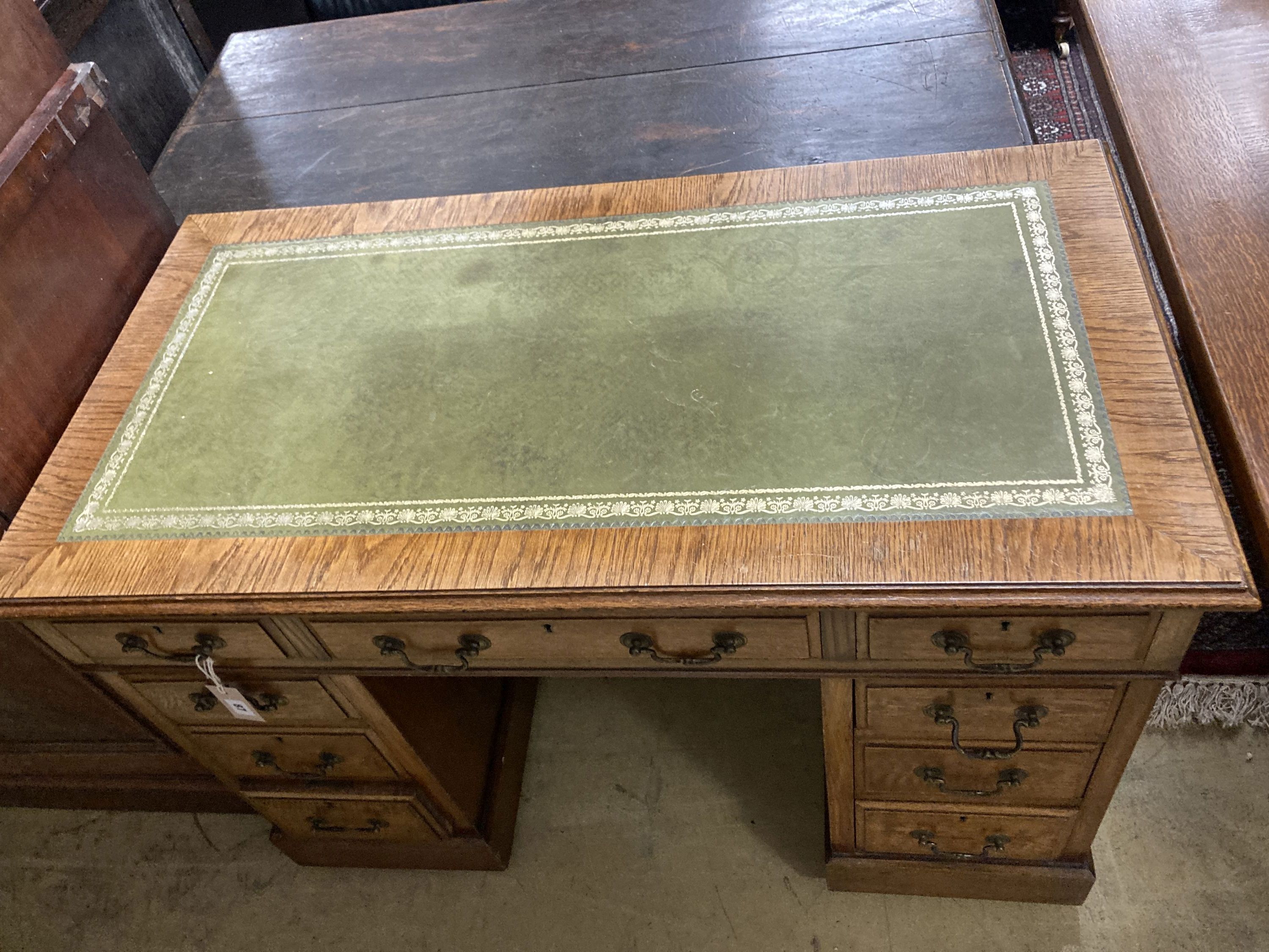 A small Victorian style oak pedestal desk, width 107cm, depth 57cm, height 76cm